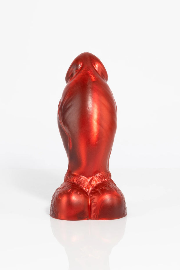 A product photo of a red minotaur dildo showing off the balls.