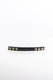 A product photo of a black pentagram-studded cock ring with grey trim.