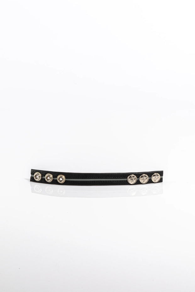 A product photo of a black pentagram-studded cock ring with grey trim.