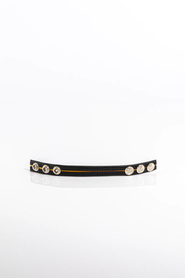 A product photo of a black leather pentagram-studded cock ring with yellow trim.