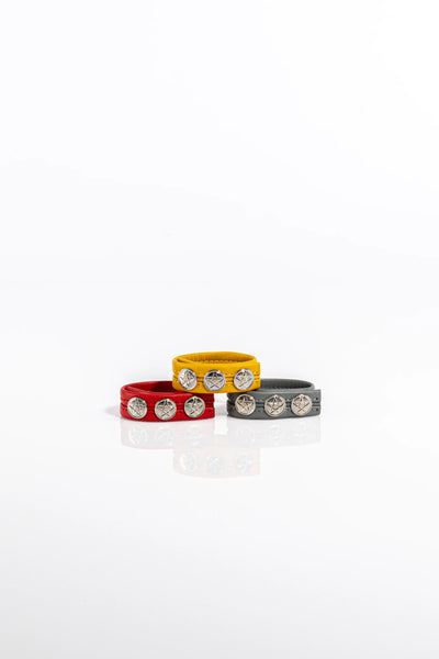 A product photo of three leather pentagram-studded cock rings.