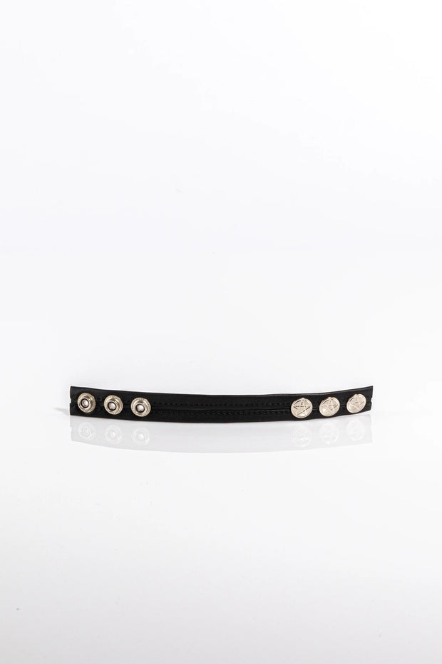 A product photo of a black trimmed black pentagram-studded cock ring.