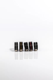 A product photo of five different coloured pentagram-studded cock rings.