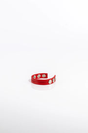 A product photo of a solid red pentagram-studded cock ring.